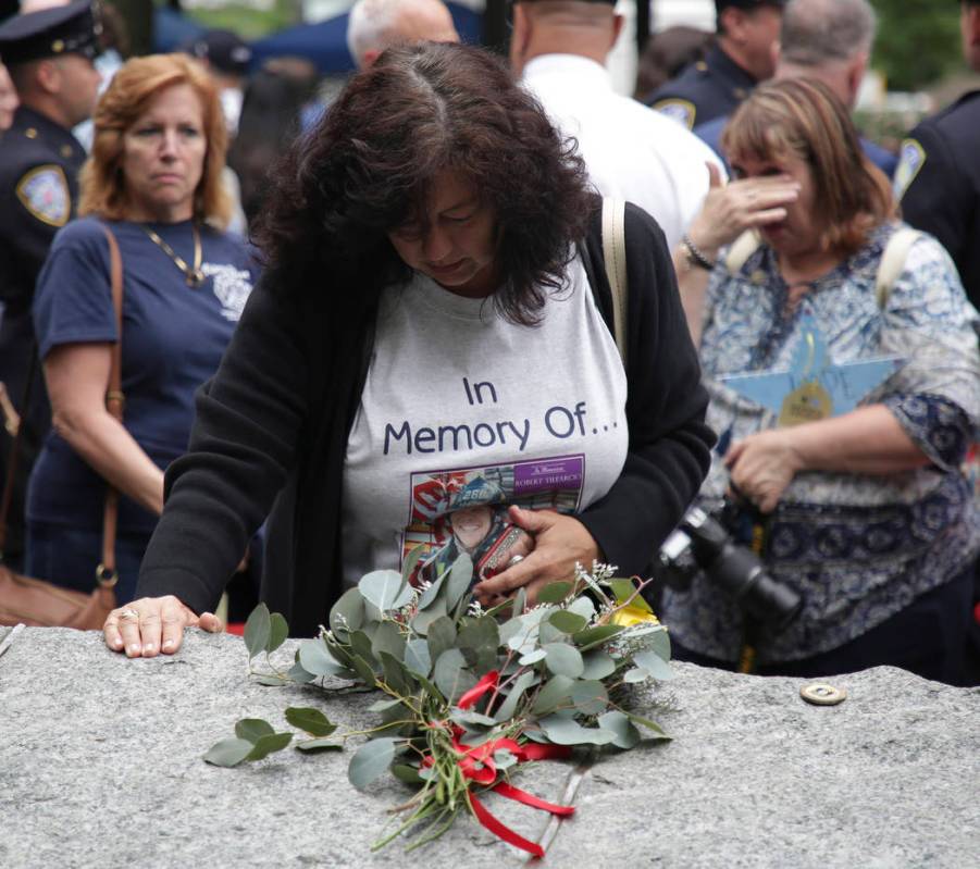 FILE- In this May 30, 2019 file photo, Tina Tilearcio pauses at a stone that is part of the new ...