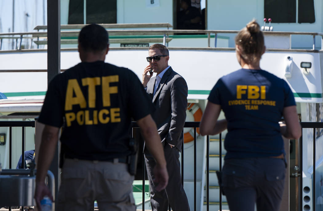 Authorities work to investigate the Truth Aquatics office on the Santa Barbara Harbor in Santa ...