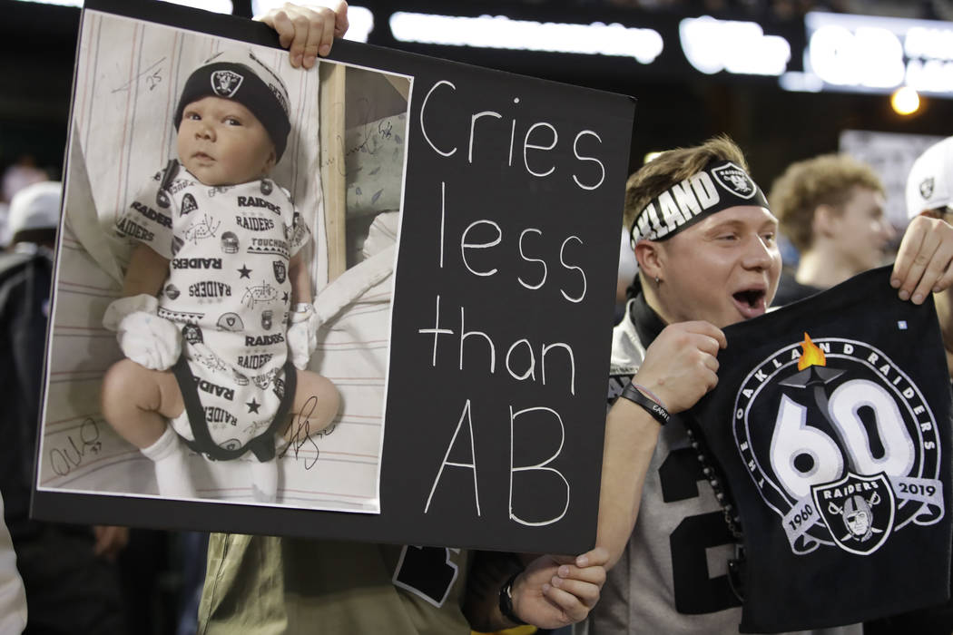 An Oakland Raiders cheers during the first half of an NFL football game against the Denver Bron ...