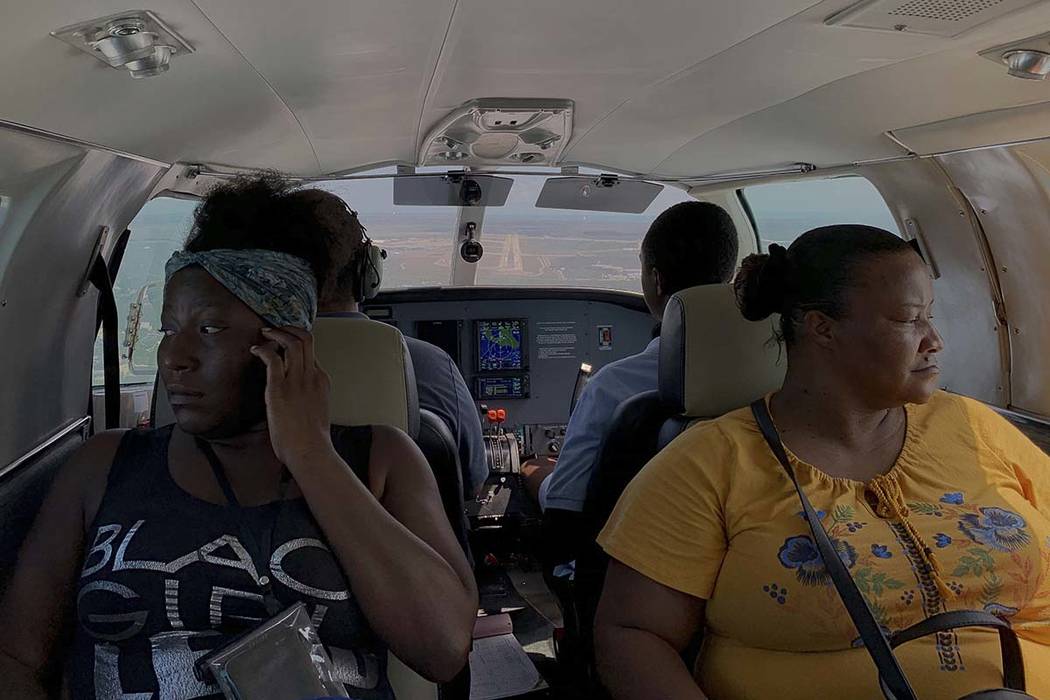 Dimple Lightbourne, left, and her mother Carla Ferguson sit in a plane as it approaches to land ...