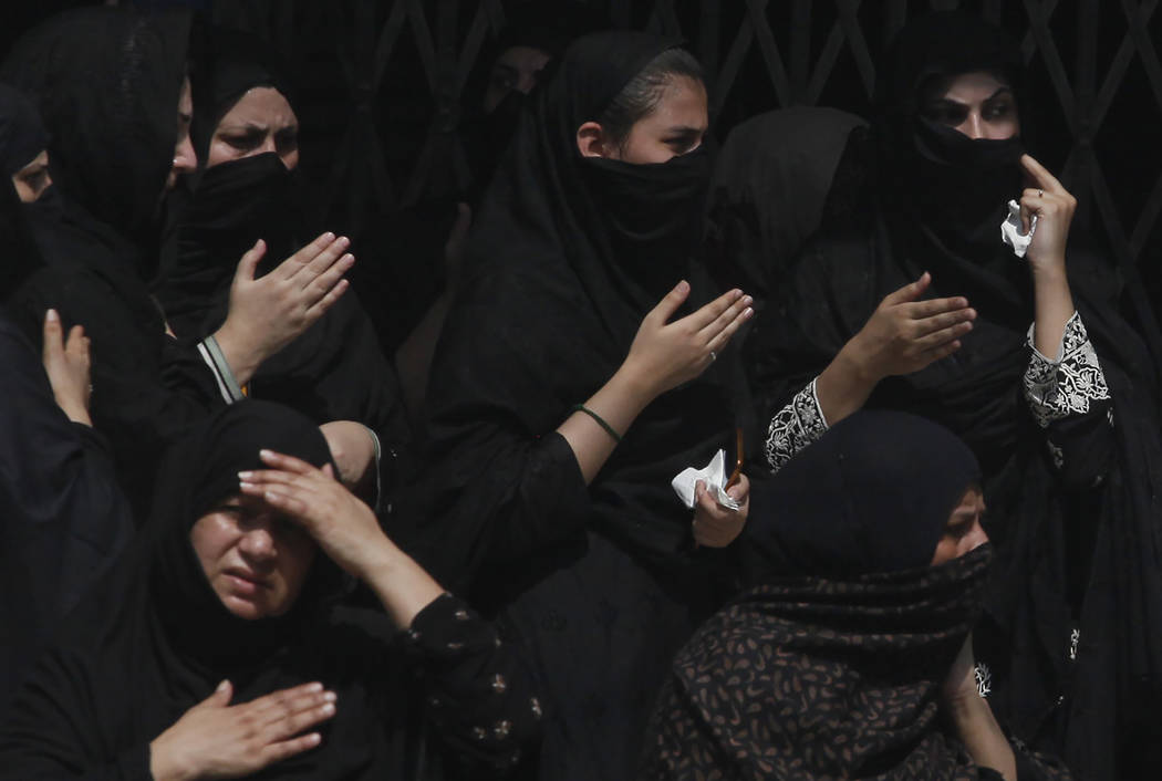 Shiite women beat their chests during a Muharram procession, in Peshawar, Pakistan, Monday, Sep ...