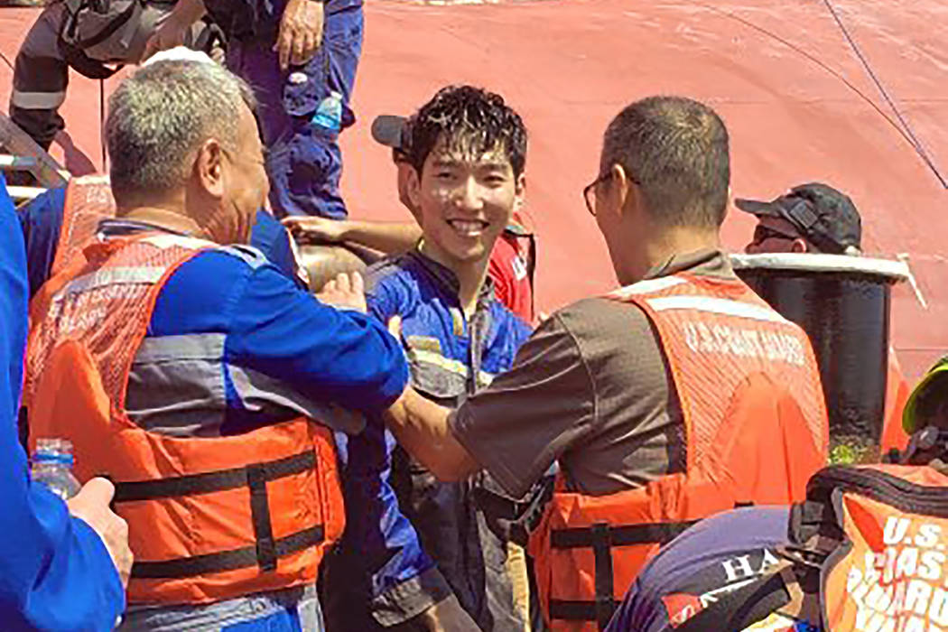 In this image released by the U.S. Coast Guard shows a crew member of the cargo ship Golden Ray ...