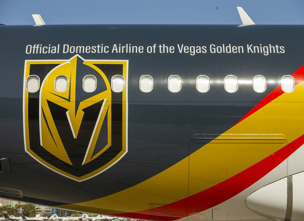 Team markings adorn the plane as Allegiant unveils a new Golden Knights-themed plane at McCarra ...