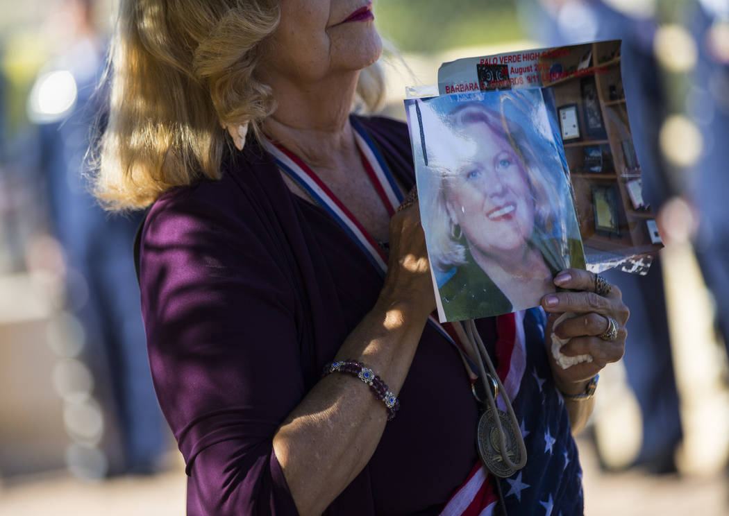 Cathy Navin holds a photo of teacher Barbara Edwards during the annual rededication ceremony re ...