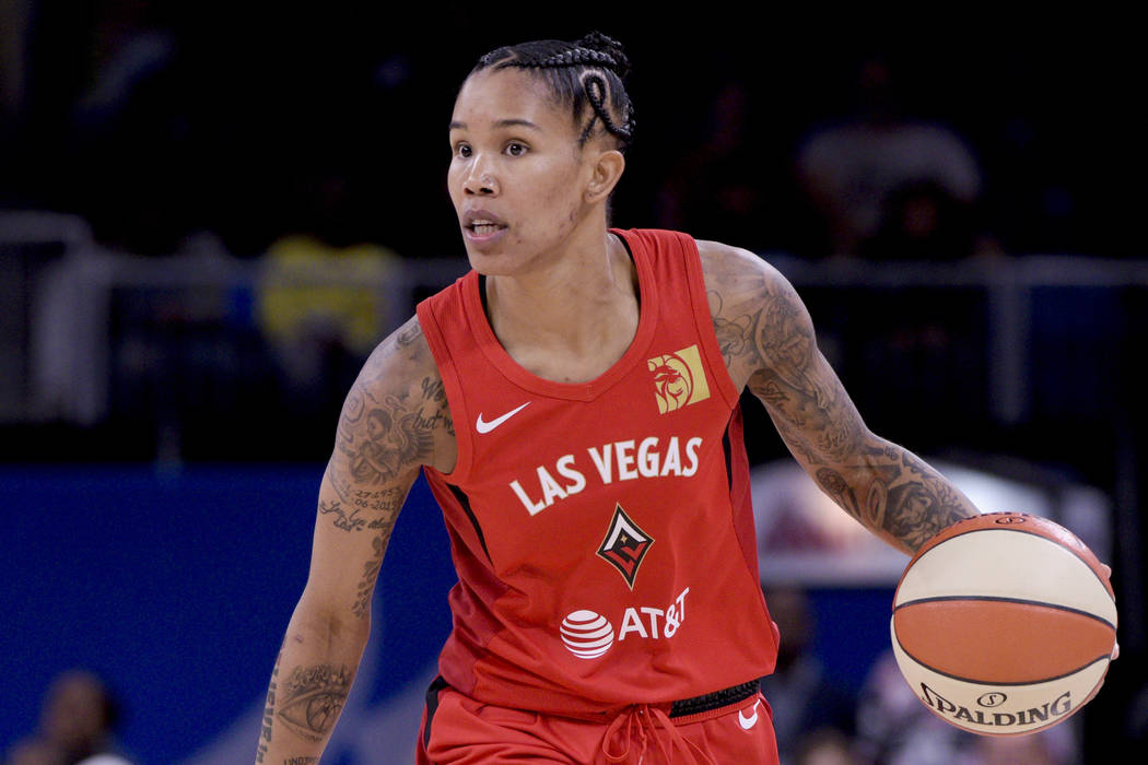 Las Vegas Aces' Tamera Young advances ball during the first half a WNBA basketball game against ...