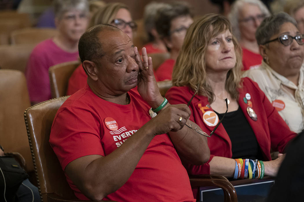 Activists and survivors of gun violence listen as House Speaker Nancy Pelosi, D-Calif., and Rep ...