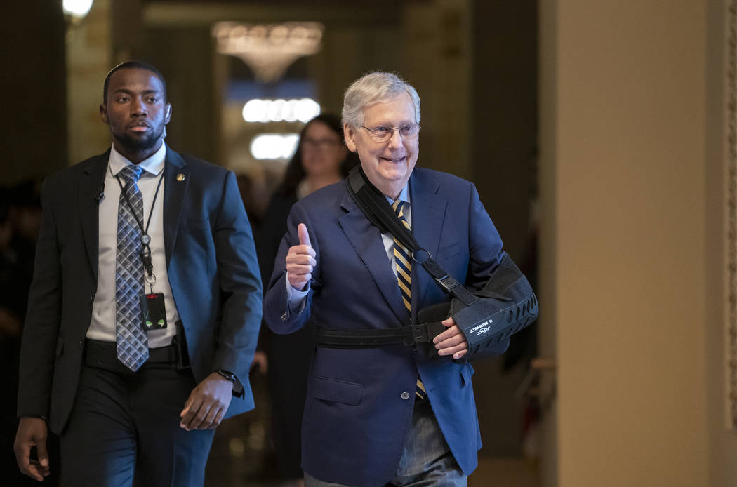 Senate Majority Leader Mitch McConnell, R-Ky., walks to the Senate chamber with his arm in a sl ...