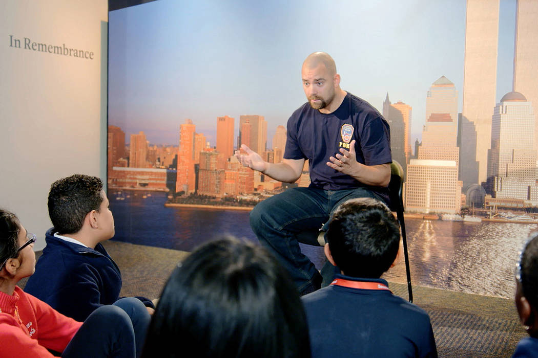 This image released by HBO shows a New York City Fireman speaking to children in a scene from t ...