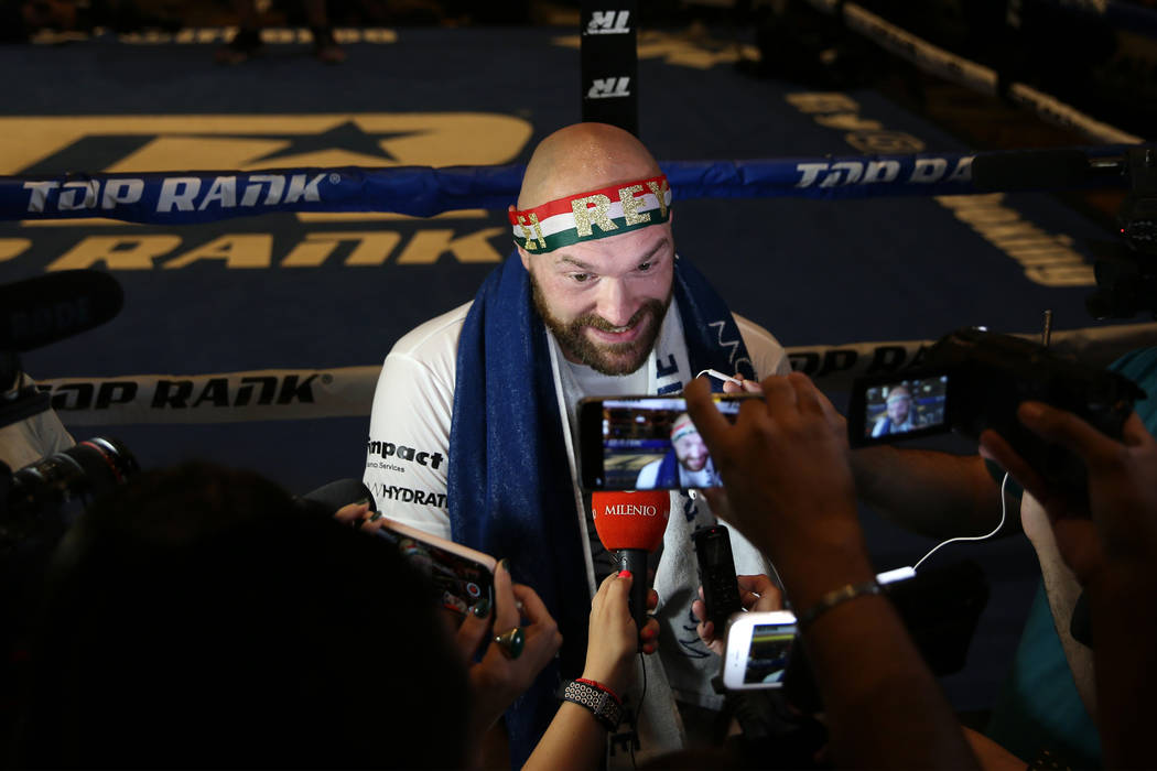 Heavyweight fighter Tyson Fury is interviewed by reporters following his open workout at the MG ...