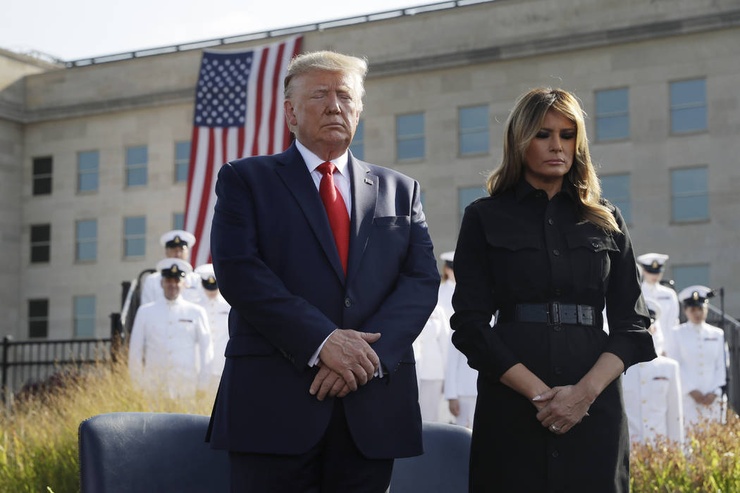 President Donald Trump and first lady Melania Trump participate in a moment of silence honoring ...