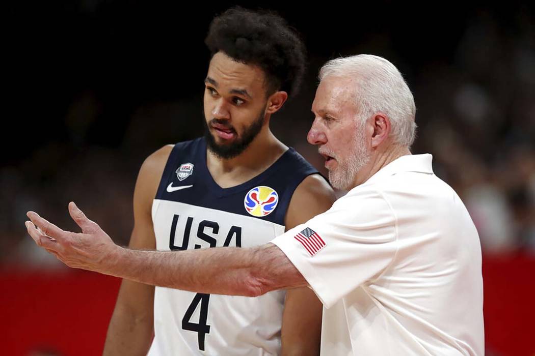 United States' coach Gregg Popovich, right instructs United States' Derrick White during a matc ...