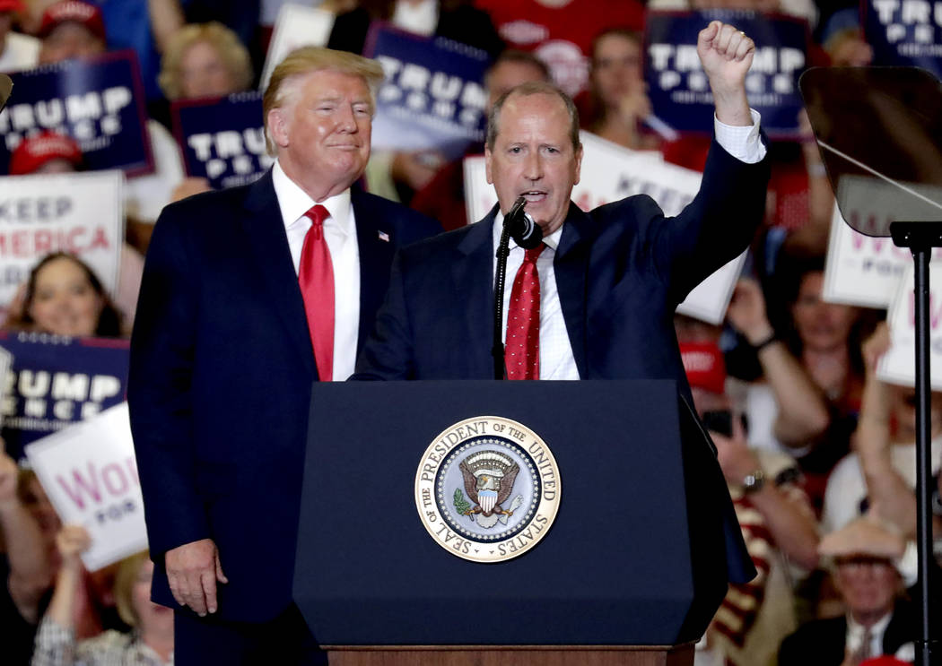 President Donald Trump, left, gives his support to Dan Bishop, right, a Republican running for ...