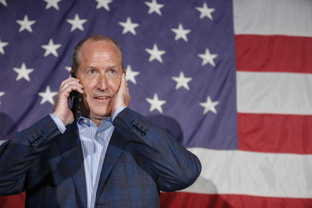 North Carolina 9th district Republican congressional candidate Dan Bishop waits to speak by pho ...