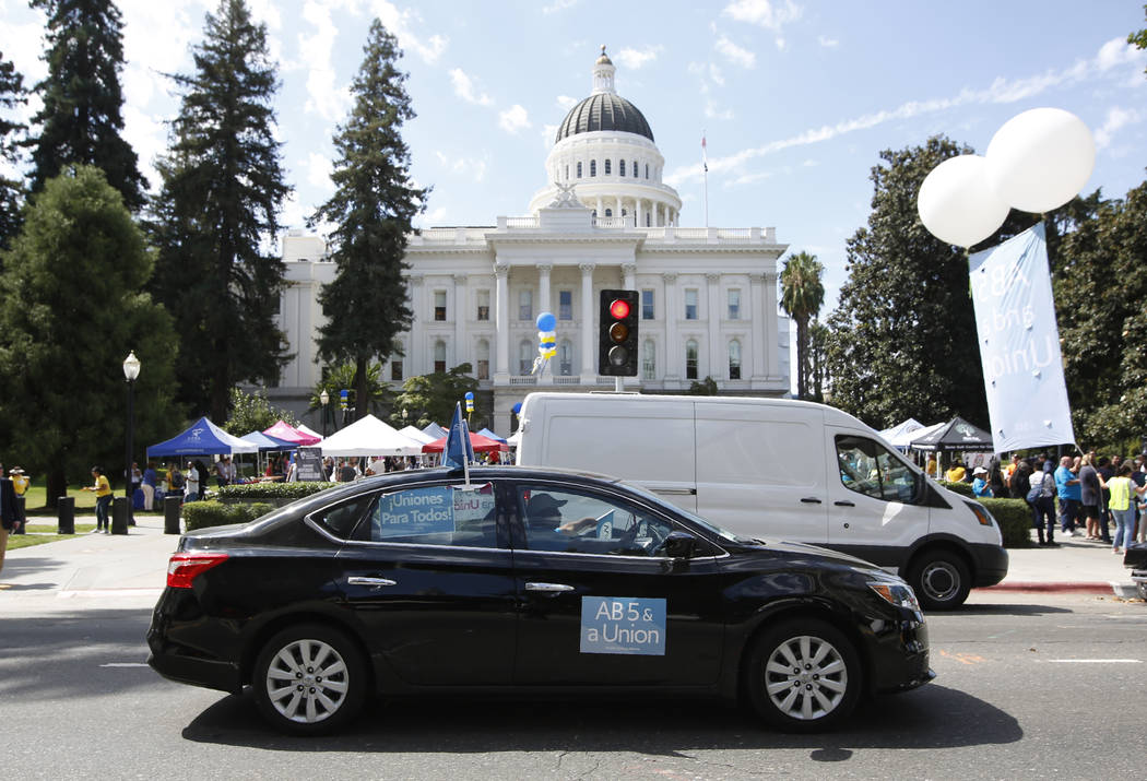 Dozens of supporters of a measure to limit when companies can label workers as independent cont ...