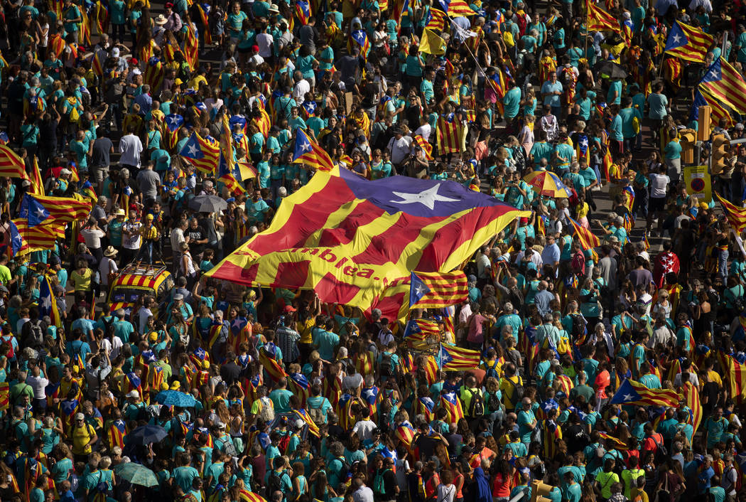 Protesters hold esteladas or independence flags as they take part in a demonstration during the ...