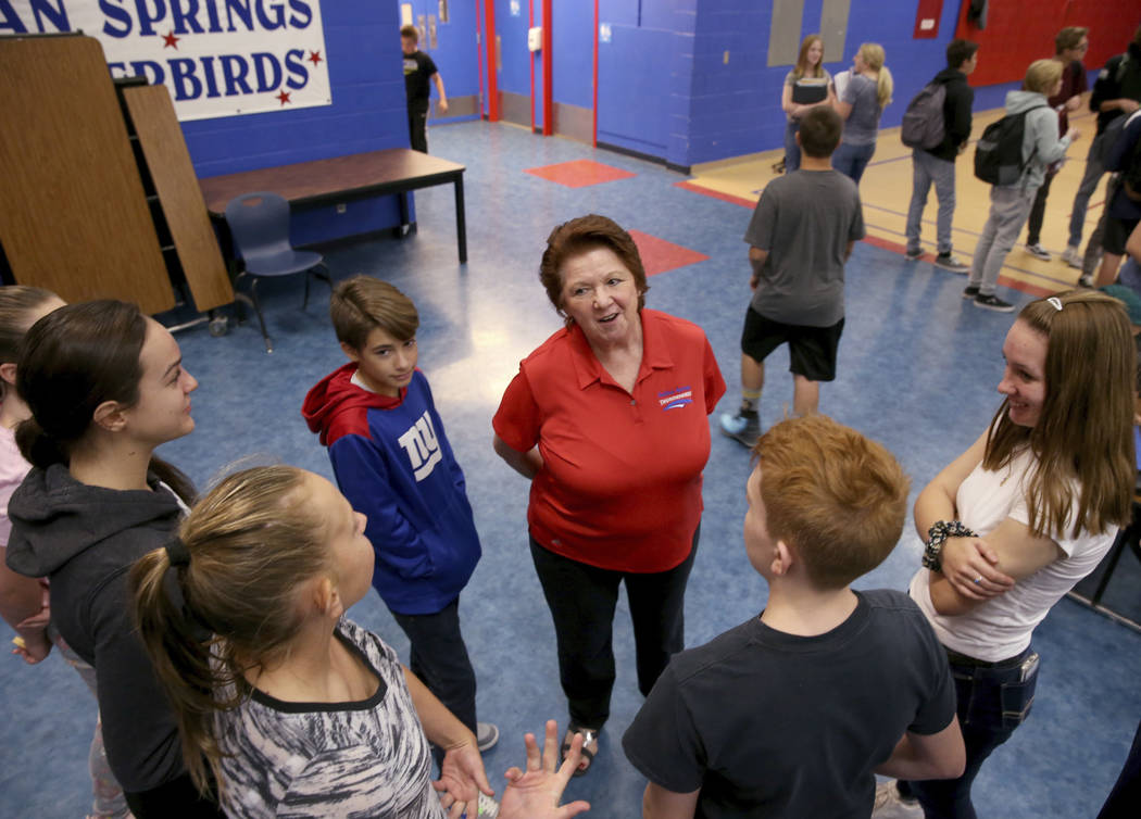 Dottie Frank, an administrative school secretary at Indian Springs School, visits with students ...