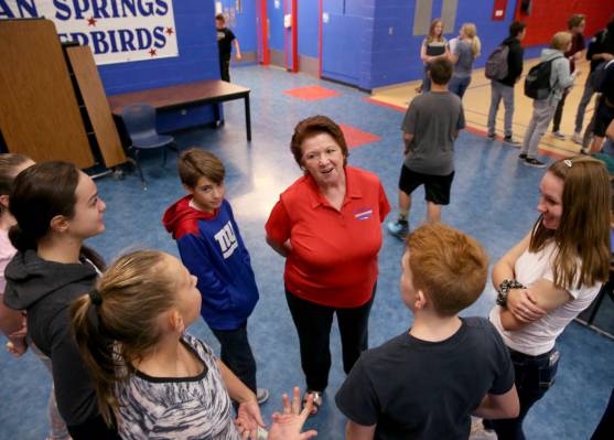 Dottie Frank, an administrative school secretary at Indian Springs School, visits with students ...