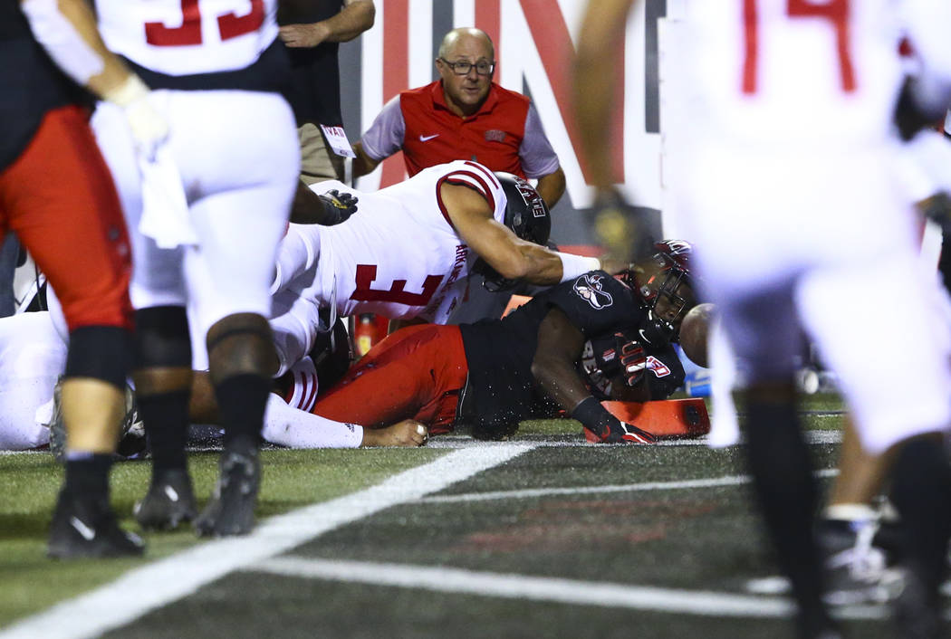 UNLV Rebels running back Charles Williams (8) scores a touchdown in front of Arkansas State Red ...
