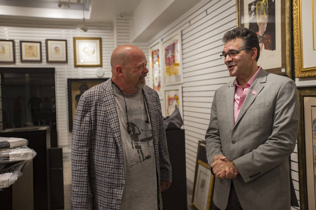 Rick Harrison, left, co-star of "Pawn Stars" and owner of Gold & Silver Pawn, talks to the Revi ...