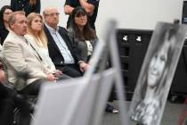 Terri Lynn Hollis' family sits in front of a photo of her during a press conference in Torrance ...