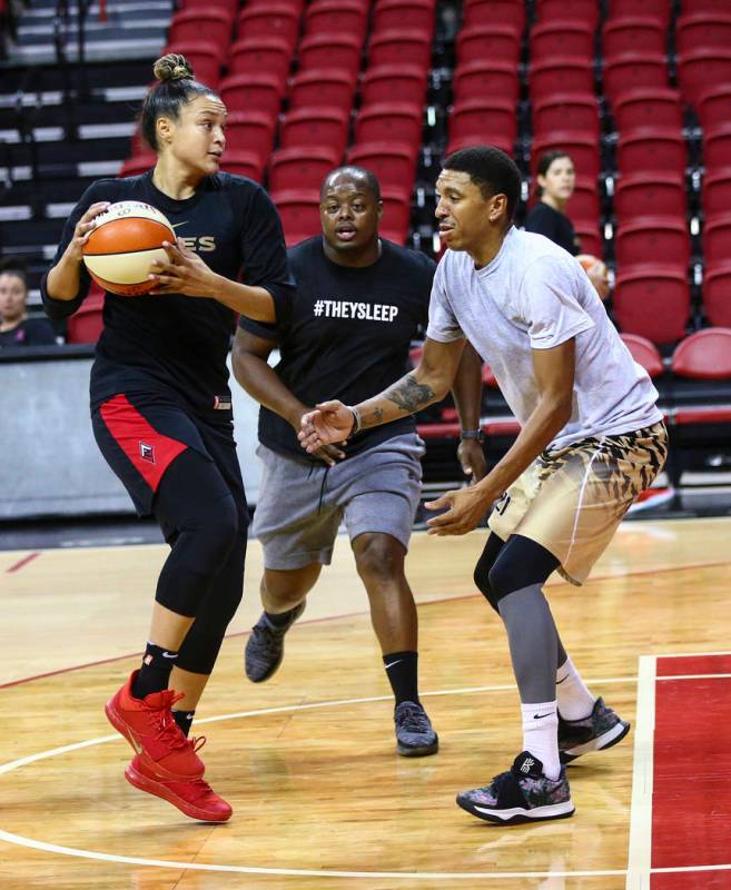 Las Vegas Aces' Kayla McBride, center, looks to pass the ball as Trevill Martin, from left, Dre ...