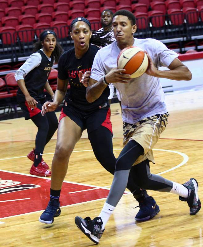 Rodney Grant, right, drives the ball under pressure from Las Vegas Aces' center A'ja Wilson dur ...