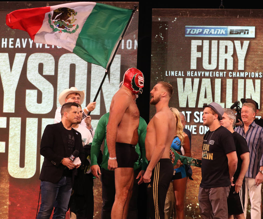 Tyson Fury, in a Mexican wrestling mask, and Otto Wallin engage in a staredown at a weigh-in on ...