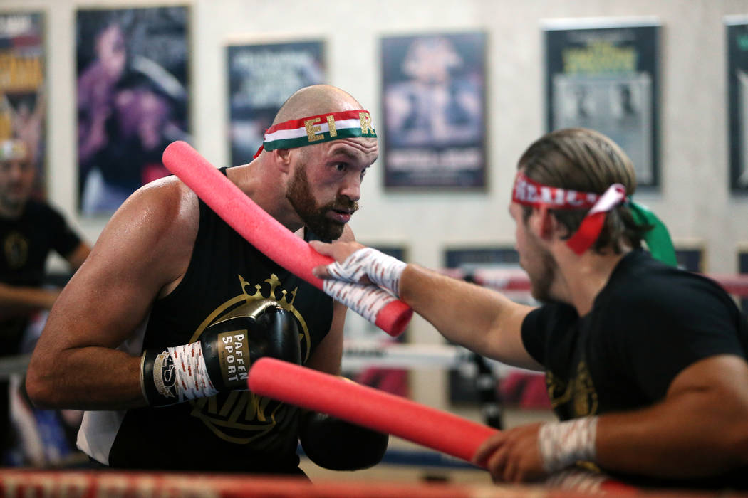 Tyson Fury, left, with her trainer Ben Davison, prepare for their upcoming heavyweight bout, at ...
