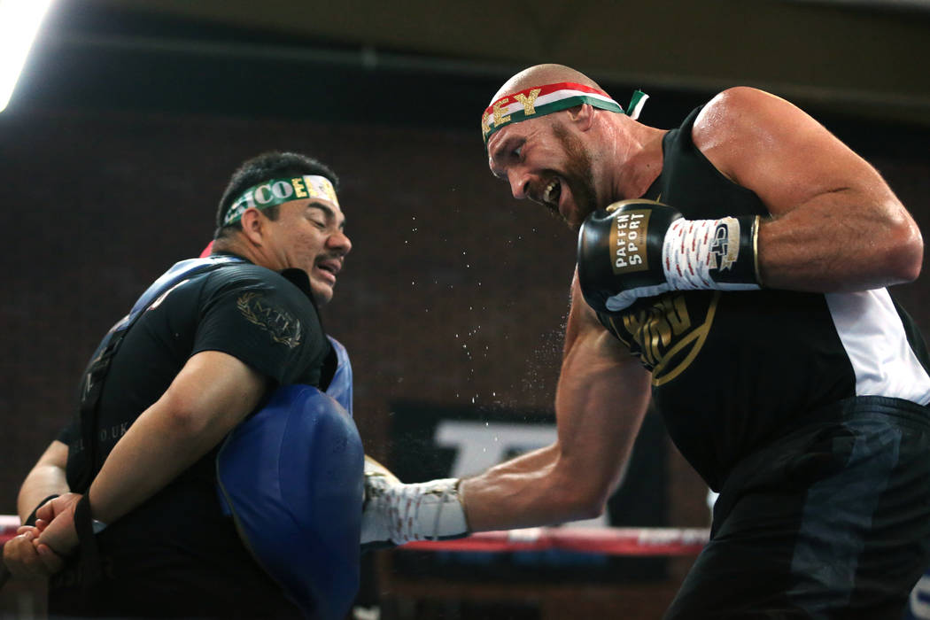 Tyson Fury, right, with his training camp assistant and outman Jorge Capetillo, prepare for the ...