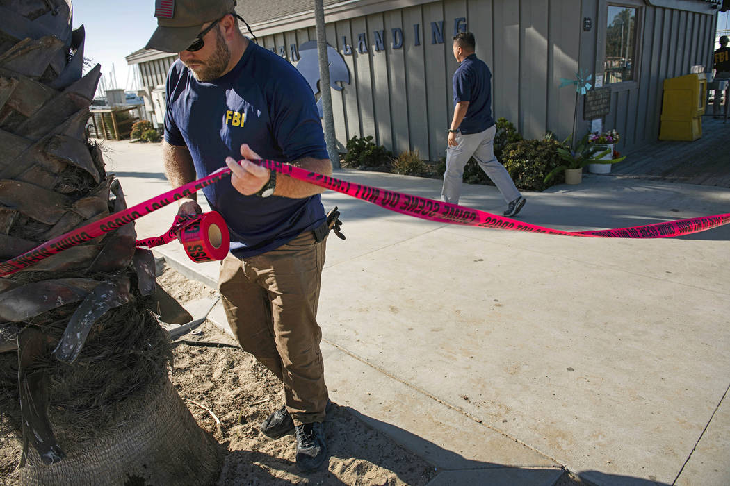 FILE - In this Sept. 8, 2019 file photo, FBI agents set a perimeter around the Truth Aquatics o ...