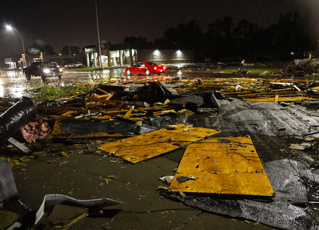 In this Tuesday, Sept. 10, 2019 photo, vehicles drive past debris littering a street after seve ...