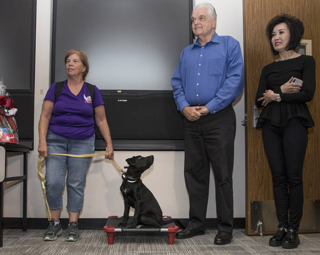 Linda Slates, left, office coordinator with Sit Means Sit Dog Training, holds the leash of ther ...