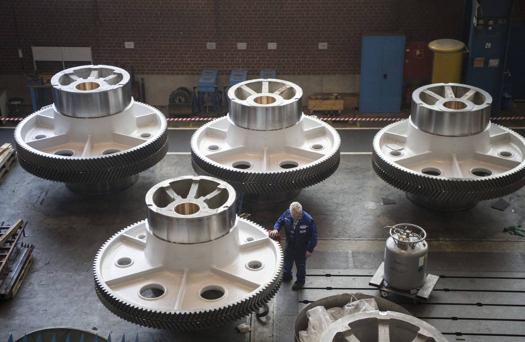 In a March 2, 2018, file photo, a worker cleans big machine parts of presses manufacturer Schü ...