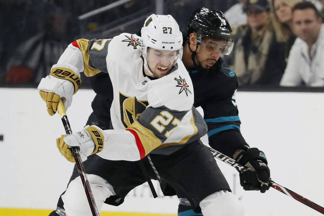 Vegas Golden Knights defenseman Shea Theodore (27) skates around San Jose Sharks left wing Evan ...