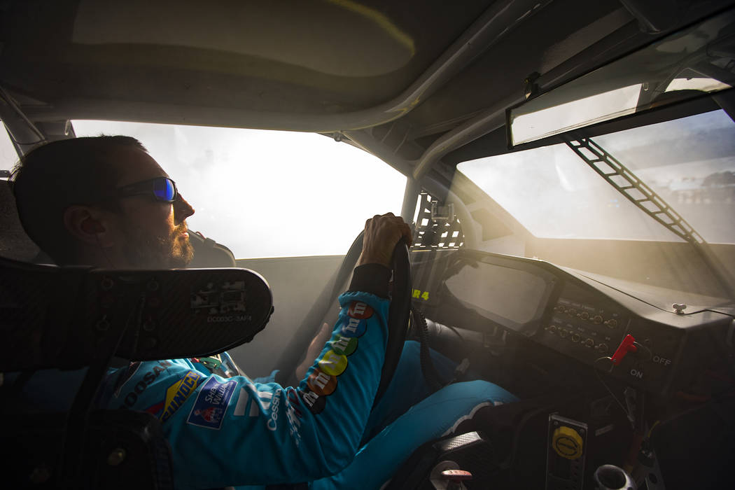 Kyle Busch performs a burnout as part of the NASCAR America Burnout Boulevard event on the Las ...