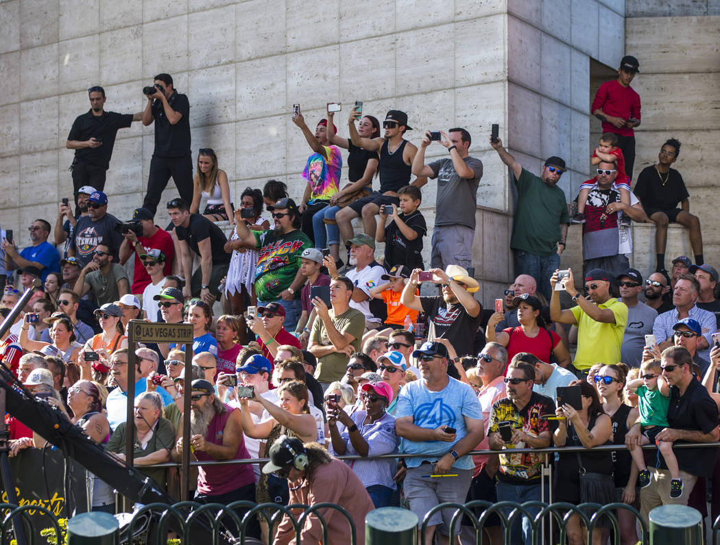 Fans watch as drivers burnout during the NASCAR America Burnout Boulevard event on the Las Vega ...