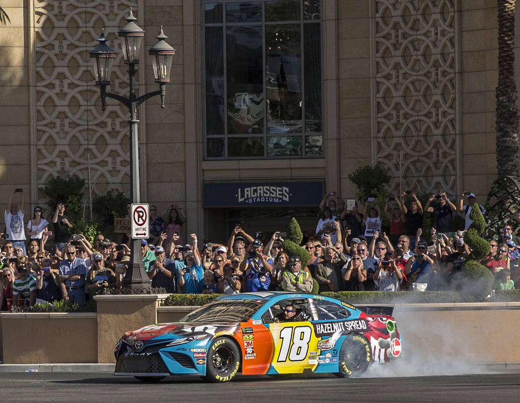 Kyle Busch does a burnout at the intersection of East Sands Avenue and South Las Vegas Boulevar ...