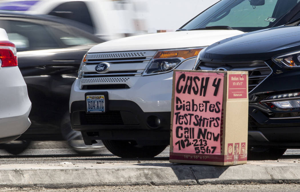 A box offering cash for diabetes testing strips is seen on West Cheyenne Avenue and North Marti ...