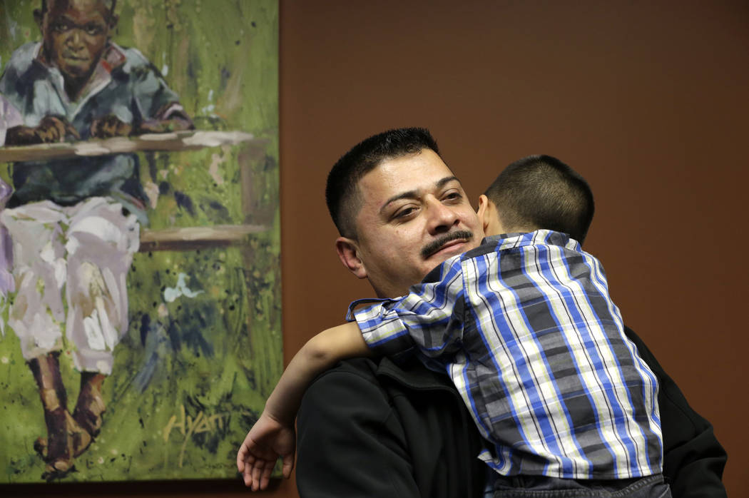 FILE - In this Friday, Oct. 17, 2014 file photo, Ignacio Lanuza-Torres holds his son, Isaiah, 4 ...