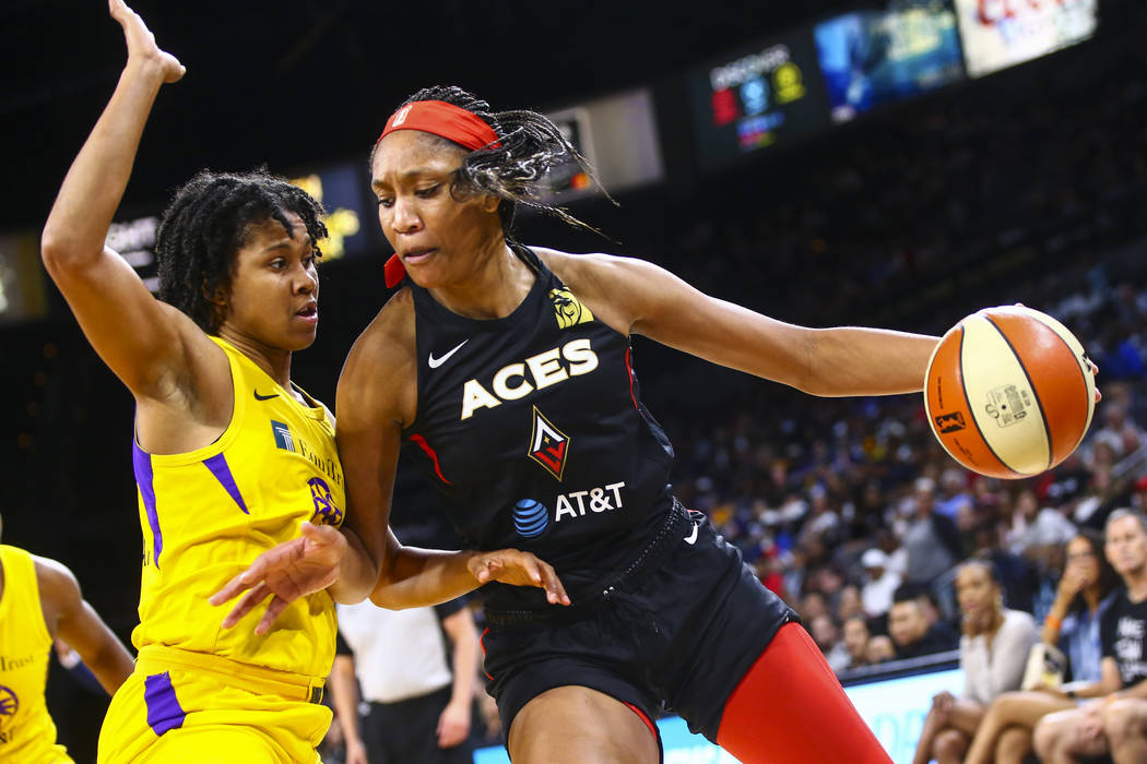 Las Vegas Aces' A'ja Wilson, right, drives to the basket against Los Angeles Sparks' Tierra Ruf ...