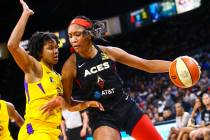 Las Vegas Aces' A'ja Wilson, right, drives to the basket against Los Angeles Sparks' Tierra Ruf ...