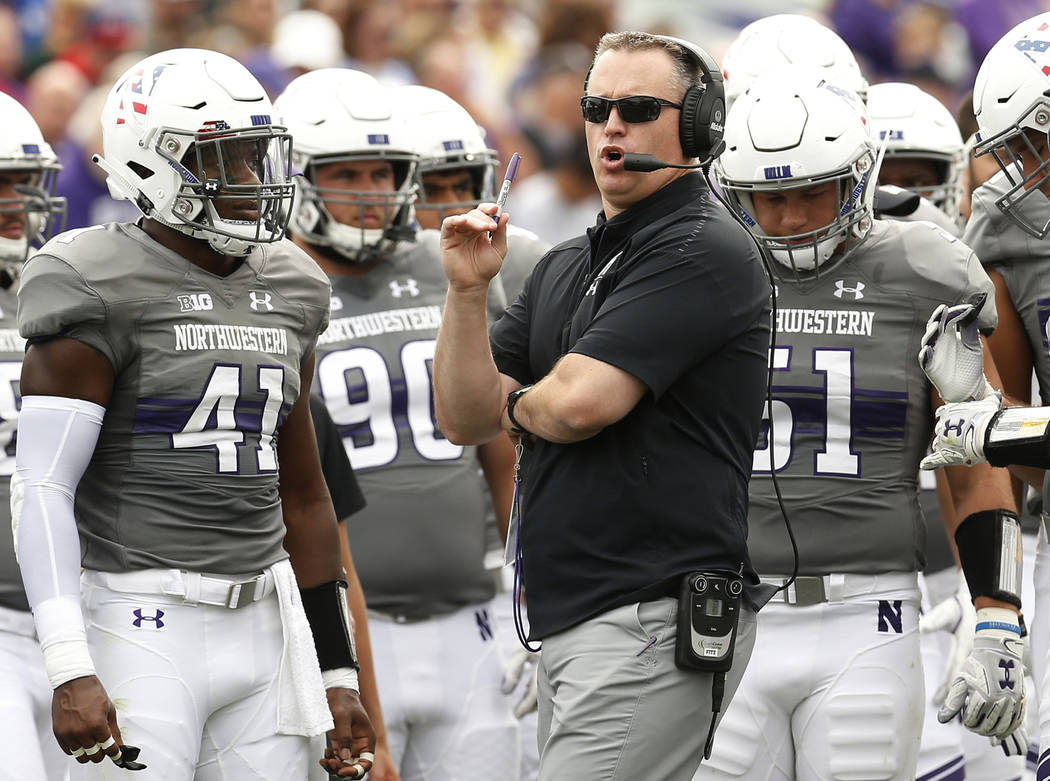 In this Saturday, Sept. 8, 2018, file photo, Northwestern coach Pat Fitzgerald speaks with his ...