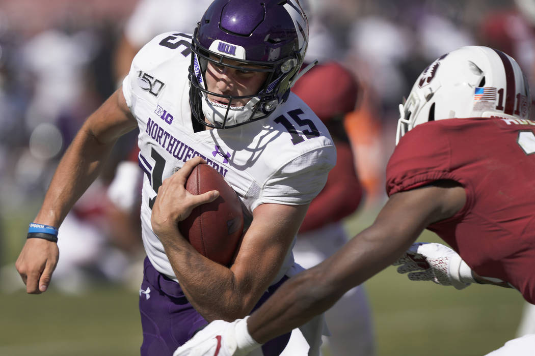 Northwestern quarterback Hunter Johnson (15) scrabbles past Stanford cornerback Paulson Adebo ( ...