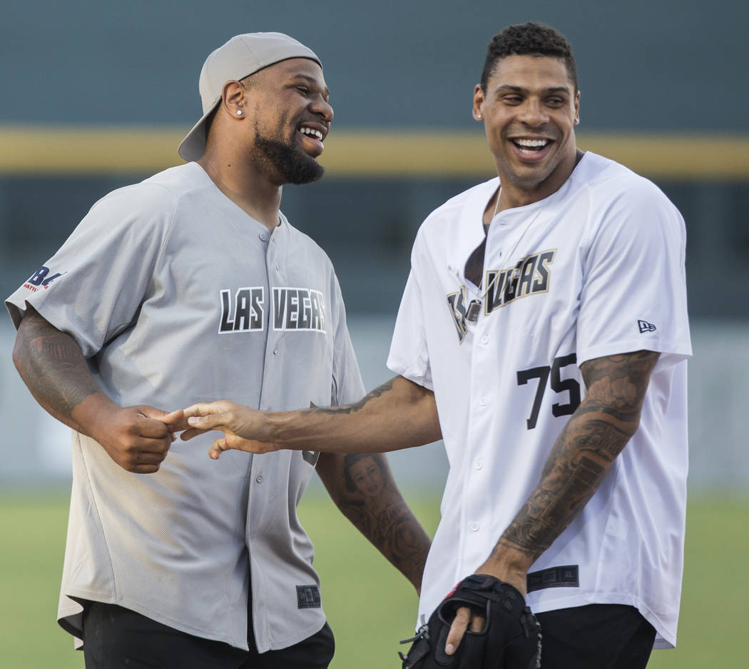 Oakland Raiders linebacker Vontaze Burfict, left, and Golden Knights right wing Ryan Reaves jok ...