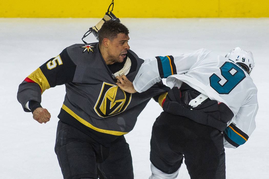 Golden Knights right wing Ryan Reaves (75) fights with San Jose Sharks left wing Evander Kane ( ...