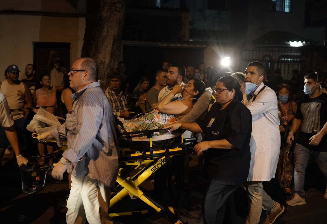 Patients are evacuated from a burning hospital in Rio de Janeiro, Brazil, Thursday, Sept. 12, 2 ...