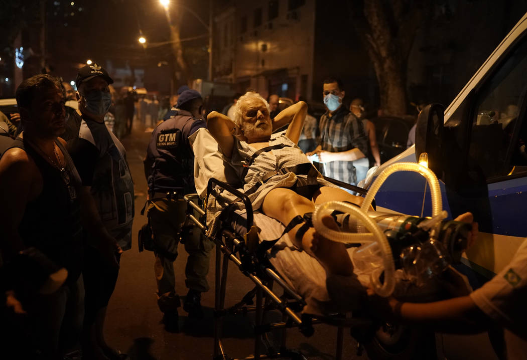 Patients are evacuated from a burning hospital in Rio de Janeiro, Brazil, Thursday, Sept. 12, 2 ...