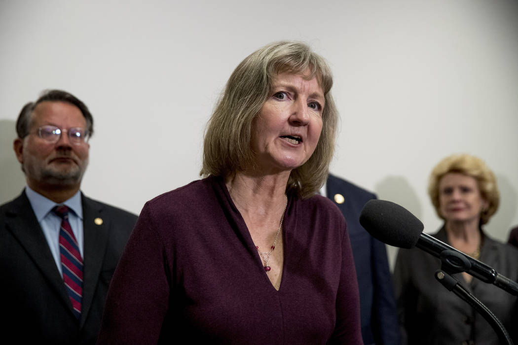 Elizabeth Whelan, the sister of Paul Whelan, accompanied by Sen. Gary Peters., D-Mich., left, a ...