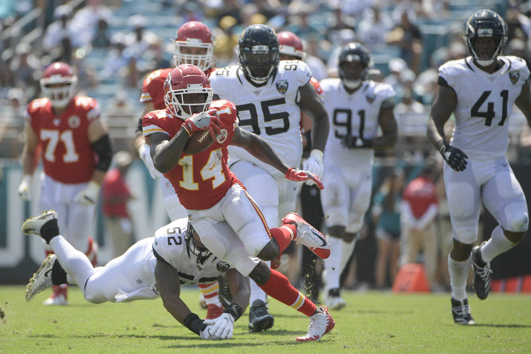 Kansas City Chiefs wide receiver Sammy Watkins (14) dodges a tackle by Jacksonville Jaguars lin ...