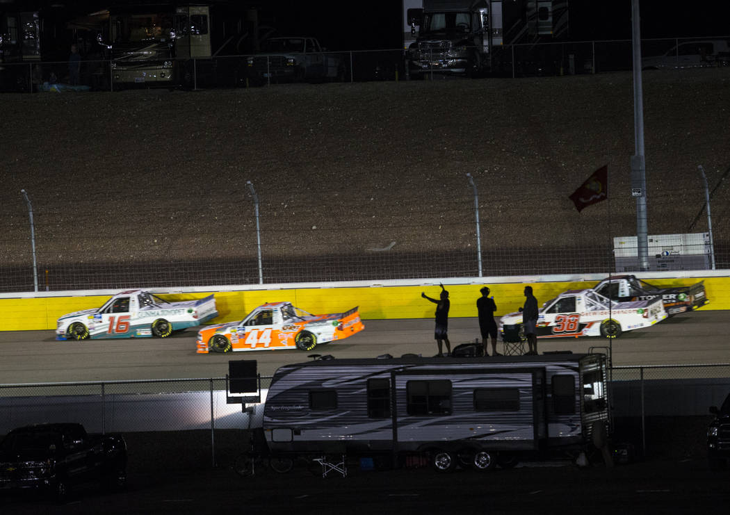 Attendees cheer as drivers compete during the NASCAR World of Westgate 200 Truck Series auto ra ...